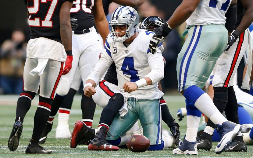 Dallas Cowboys quarterback Dak Prescott (4) flexes after making a first down on a run during...