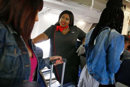 Southwest flight attendant Kelanie Watty, in her new uniform, talked to passengers Monday as...