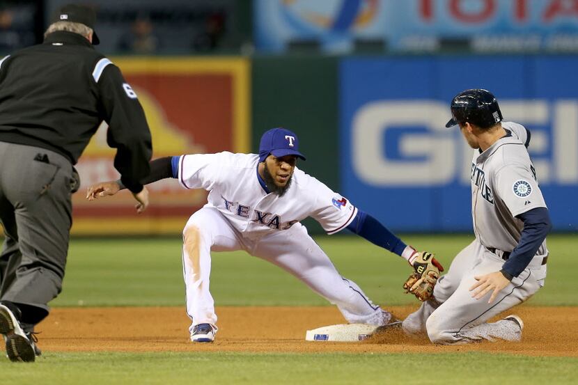 Texas Rangers shortstop Elvis Andrus (1) makes the tag out on a stealing Seattle Mariners...