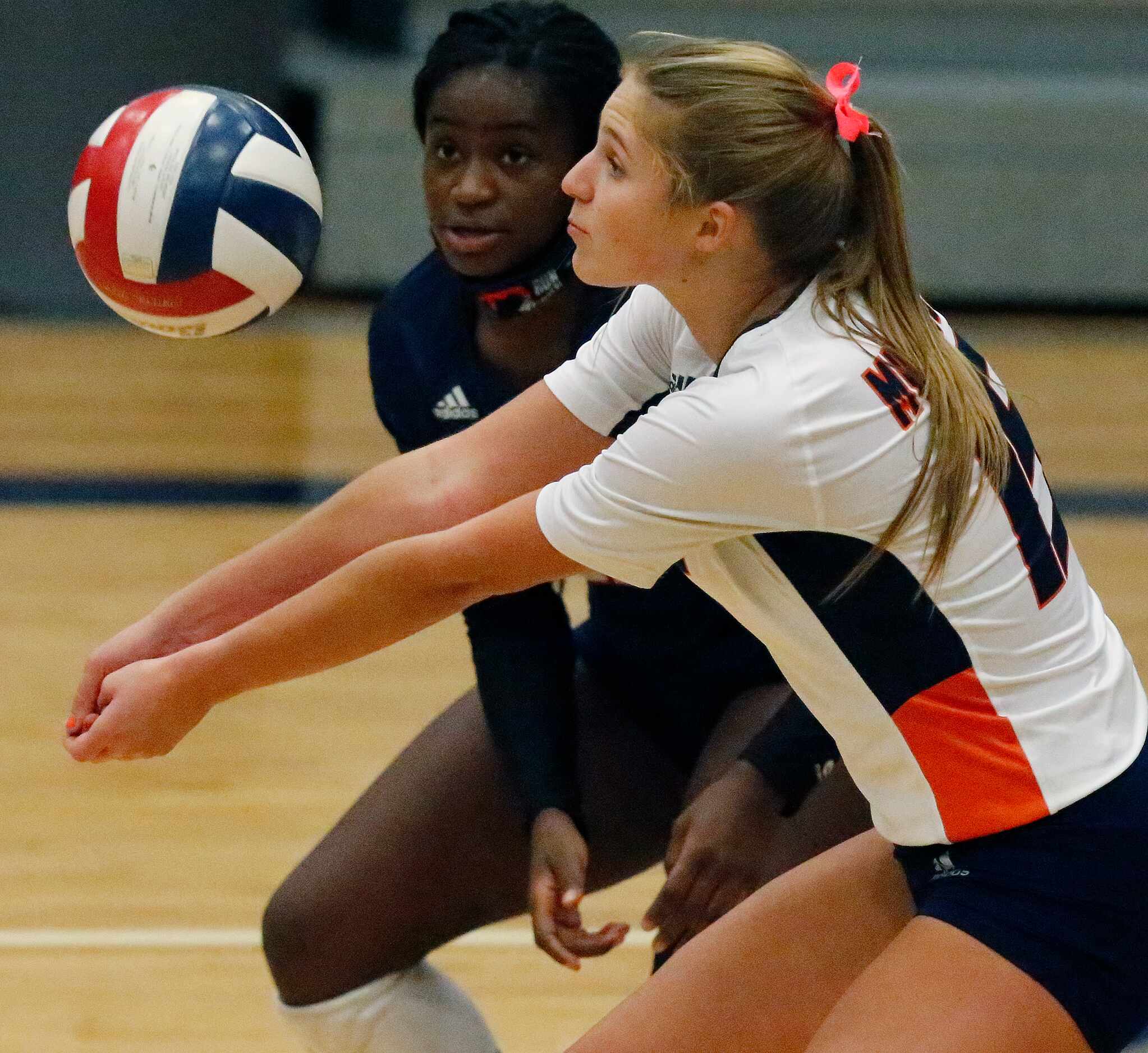 Sachse High School outside hitter Macy Taylor (15) receives a serve during game one as...