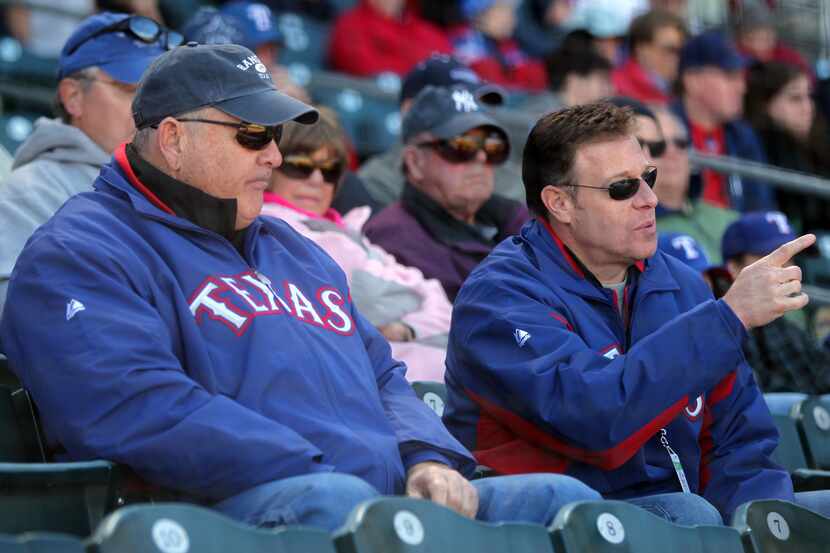 Texas Rangers owners Nolan Ryan and Chuck Greenberg watch as the Texas Rangers played the...