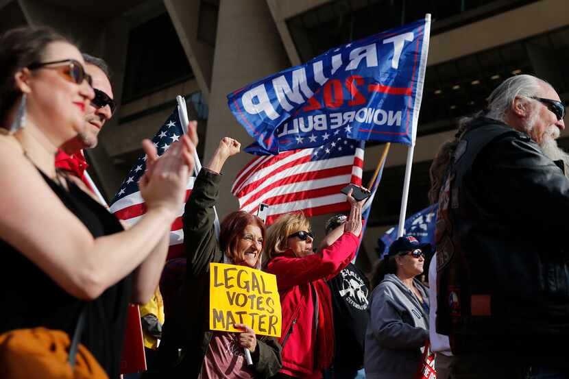 Demonstrators listen to speakers at Saturday's rally outside Dallas City Hall.