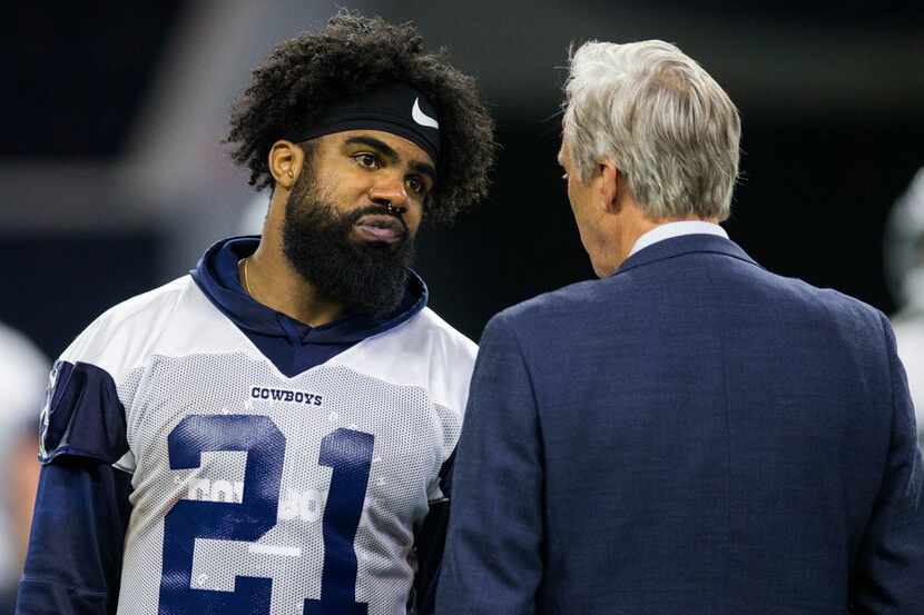 Dallas Cowboys running back Ezekiel Elliott (21) talks with Rich Dalrymple, senior vice...