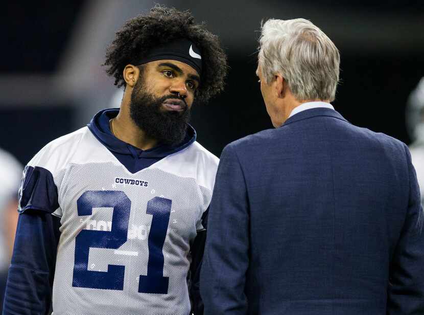 Dallas Cowboys running back Ezekiel Elliott (21) talks with Rich Dalrymple, senior vice...