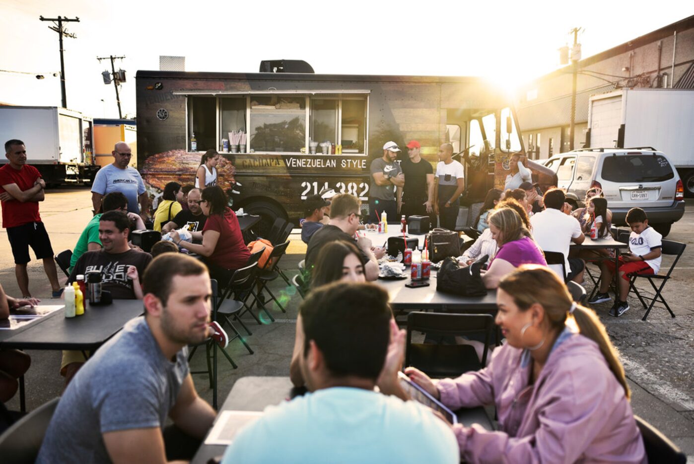 Customers fill seats outside of food truck Sabor Venezolano Express in Carrollton.