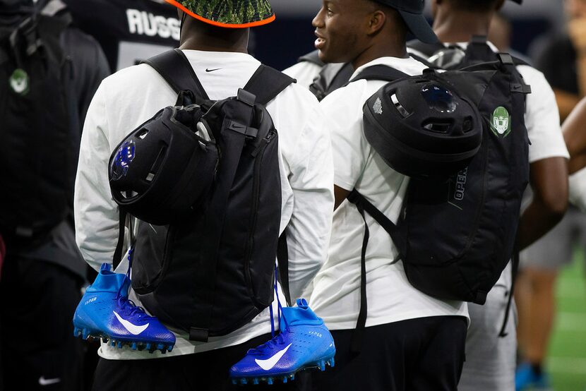 Players carry new Nike cleats and backpacks during the third day of The Opening at The Star...