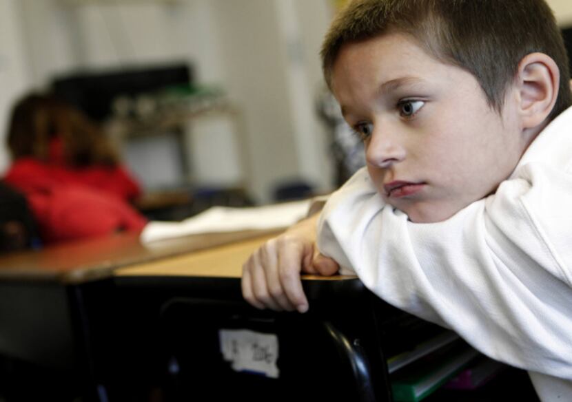 First-grader Christian Garcia is lost in thought during class at City Park Elementary in...
