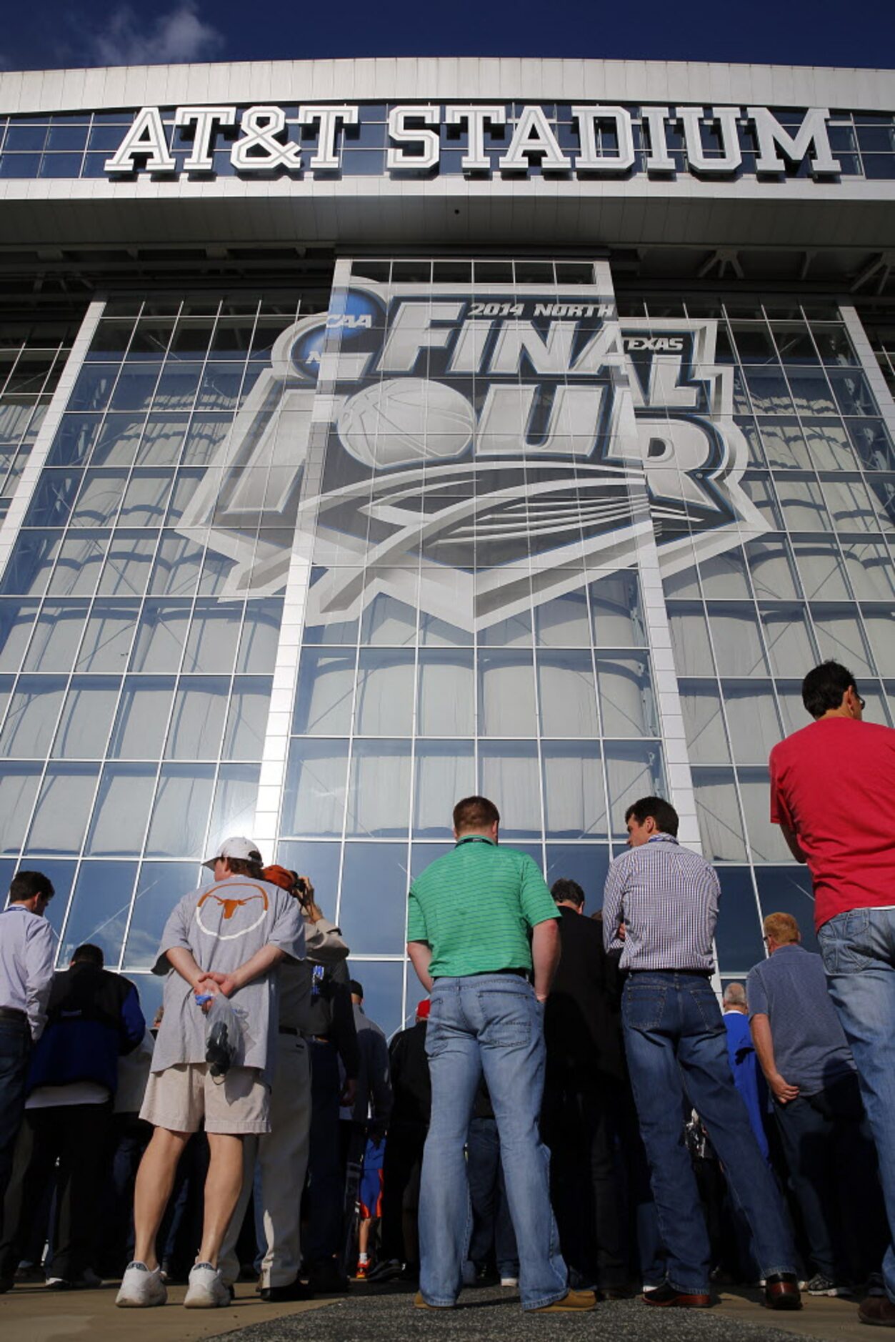 Basketball fans file into AT&T Stadium in Arlington for the NCAA National Basketball...