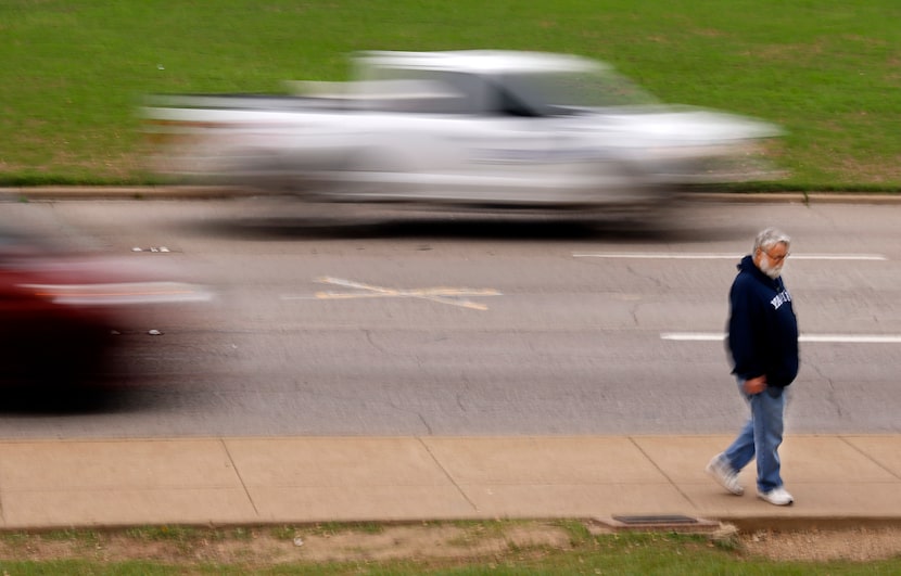 Tourist Brendan O’Connor of Manchester, N.H., passes by the X on Elm St. on Nov. 16, 2023.