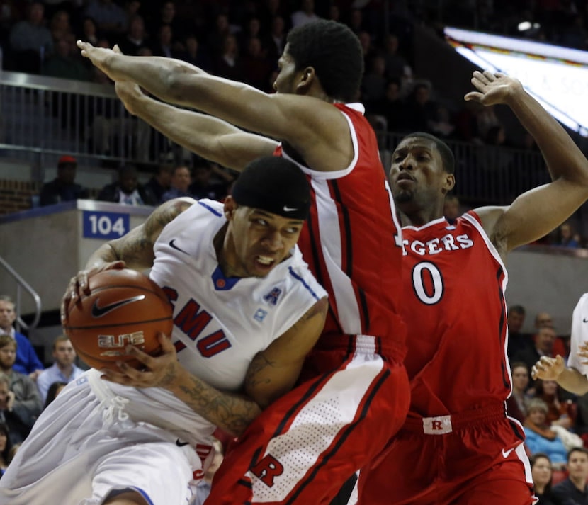 SMU guard Keith Frazier (4) tries to move the ball back inside, as Rutgers forward  Kadeem...