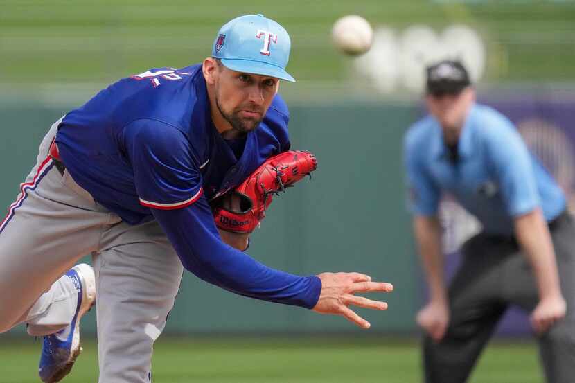 Texas Rangers pitcher Nathan Eovaldi delivers during the first inning of a spring training...