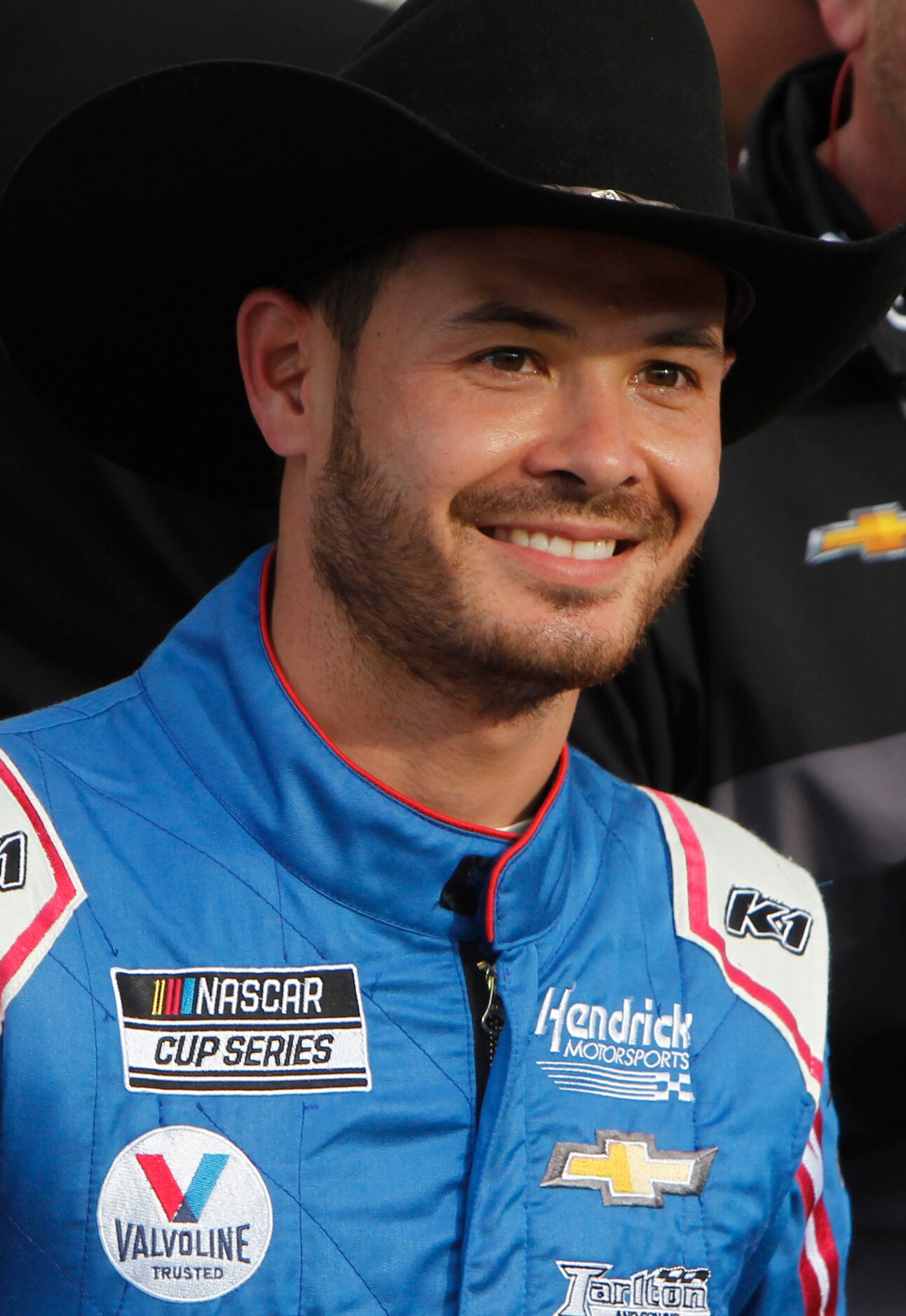 Driver Kyle Larson poses for media cameras following his victory in the NASCAR Autotrader...