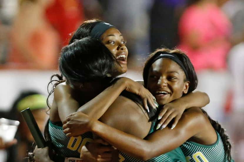 DeSoto's girls hug anchor Bryannia Murphy,C after winning in the 6A girls 4x400 relay in...