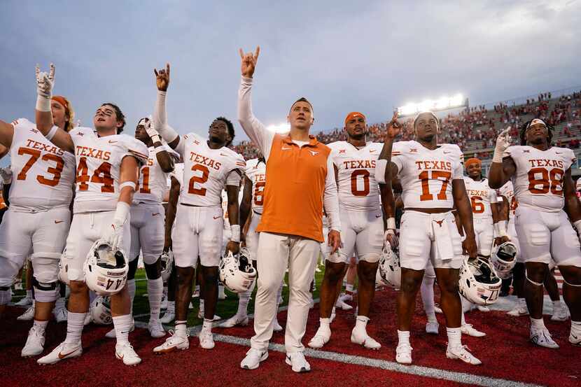 Texas head coach Steve Sarkisian, center, stands with his team after their win over Houston...
