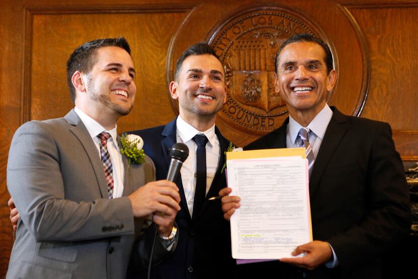 Newlyweds Jeff Zarrillo (left) and Paul Katami (center) posed for photos after their Los...