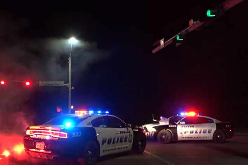 Dallas police use flares to block off the road after a man on a bike was struck and killed...