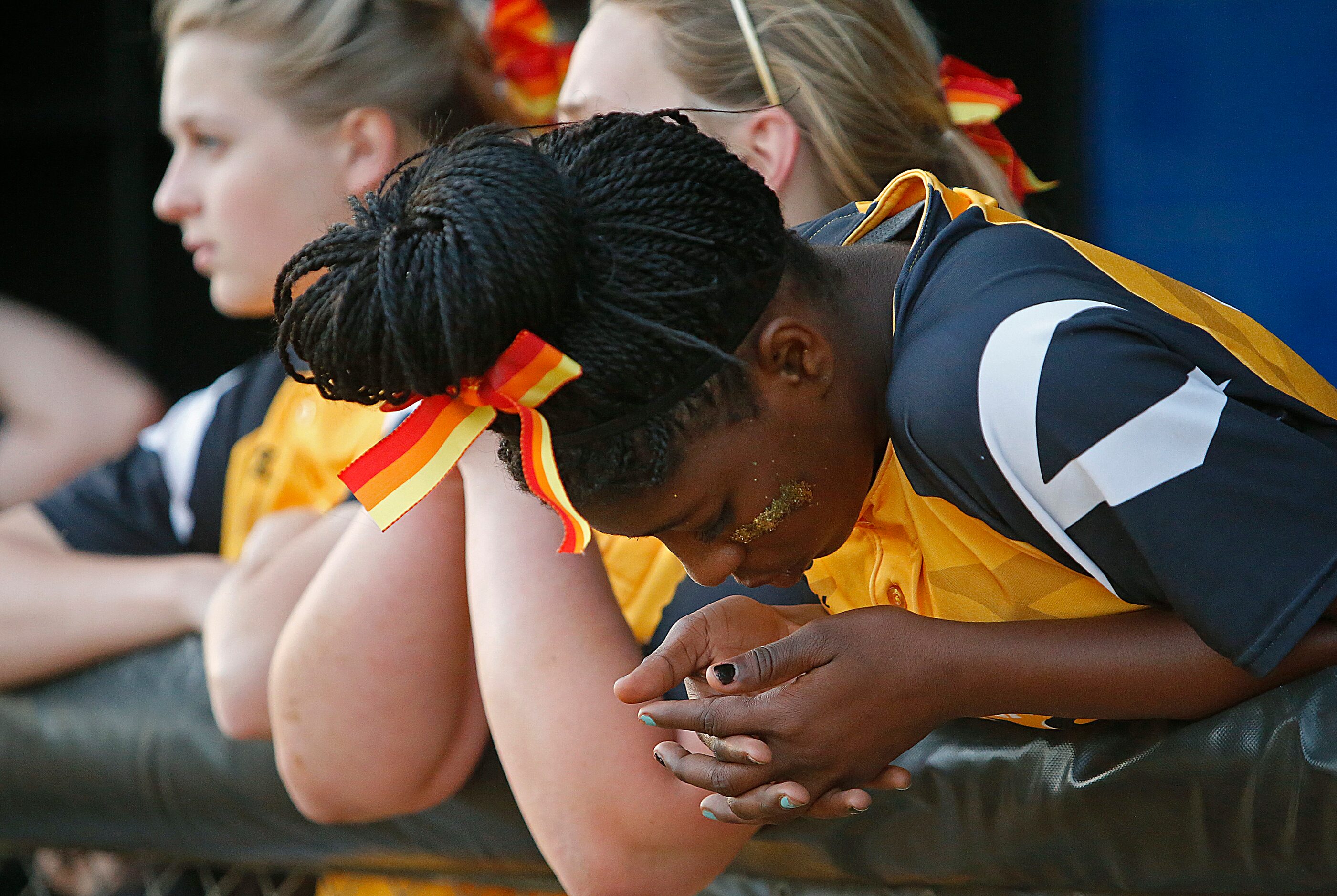 Plano East High School's Malea Dickerson (16) listens to her coach address the team between...