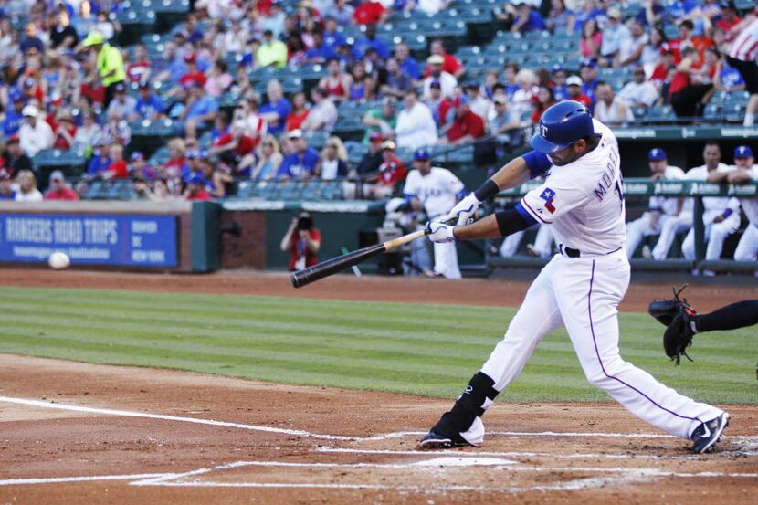 Texas Rangers designated hitter Mitch Moreland (18) hits a single to bring in two runs in...