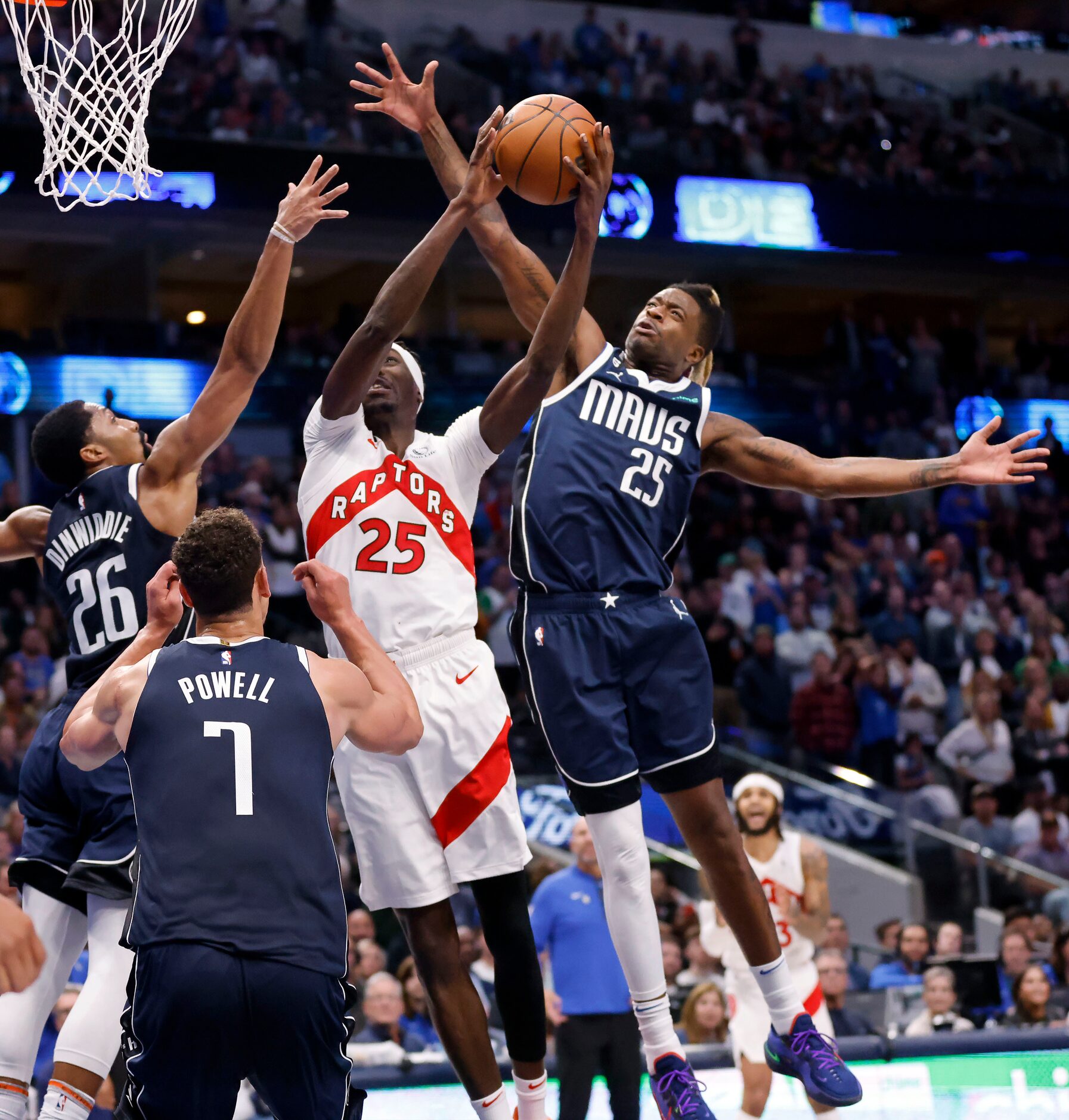 Dallas Mavericks forward Reggie Bullock (25) blocks Toronto Raptors forward Chris Boucher’s...