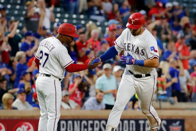 Texas Rangers third baseman Joey Gallo (13) shakes hands with Texas Rangers third base coach...