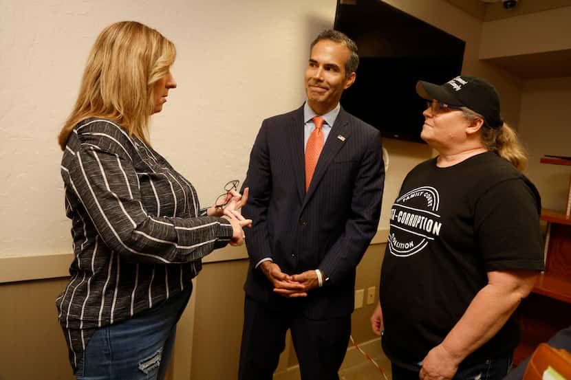 Melanie Fletcher, left, and Jodi Mueller, right talk to George P. Bush, who is in a runoff...
