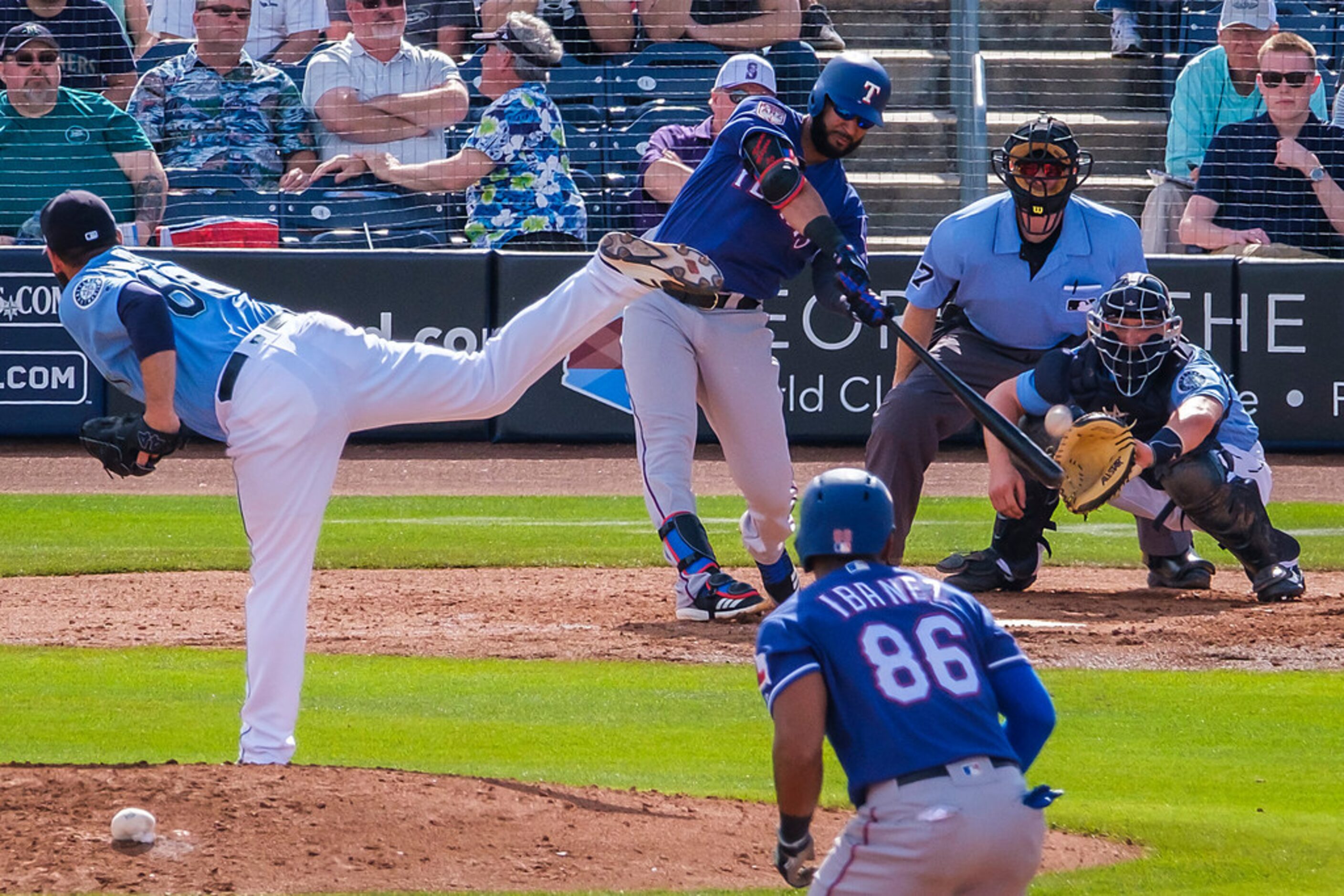 Texas Rangers outfielder Nomar Mazara drives home infielder Andy Ibâñez (86) with a...