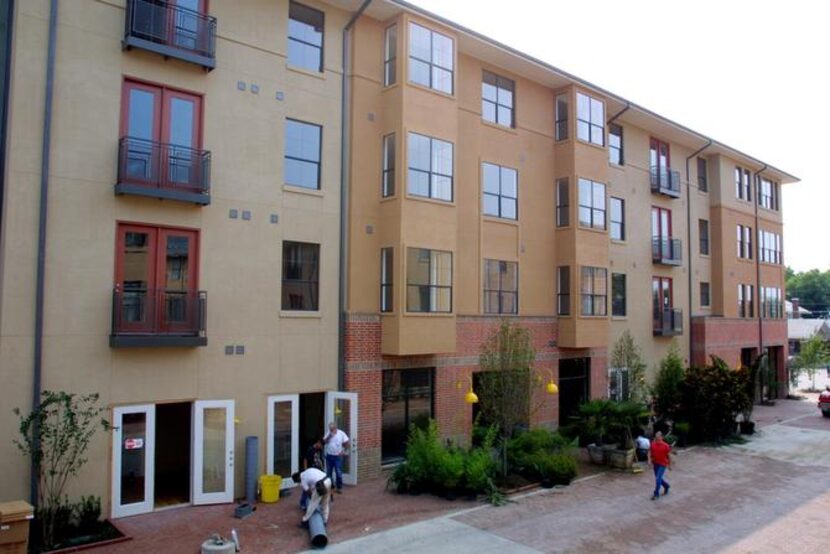 
Workers put the finishing touches on the Eastside Village Phase II apartments in downtown...