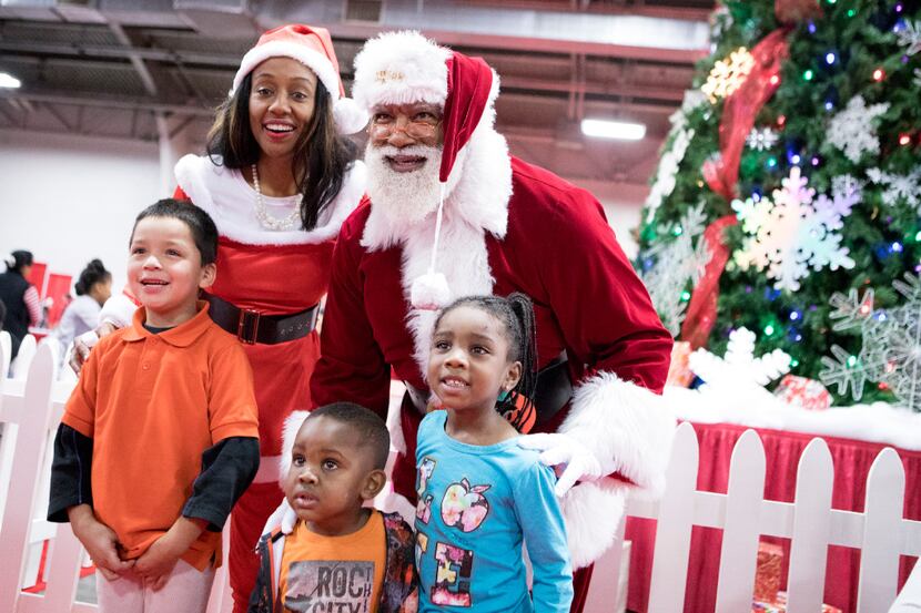 Santa and Mrs. Claus take photos with kids during the S.M. Wright Foundation's 18th Annual...