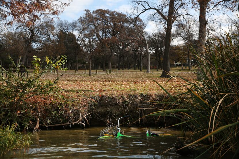 A LimeBike rental bike floats in White Rock Lake in Dallas on Dec. 4, 2017.