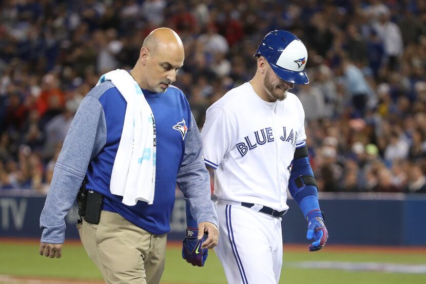 TORONTO, ON - APRIL 13: Josh Donaldson #20 of the Toronto Blue Jays exits the game with...