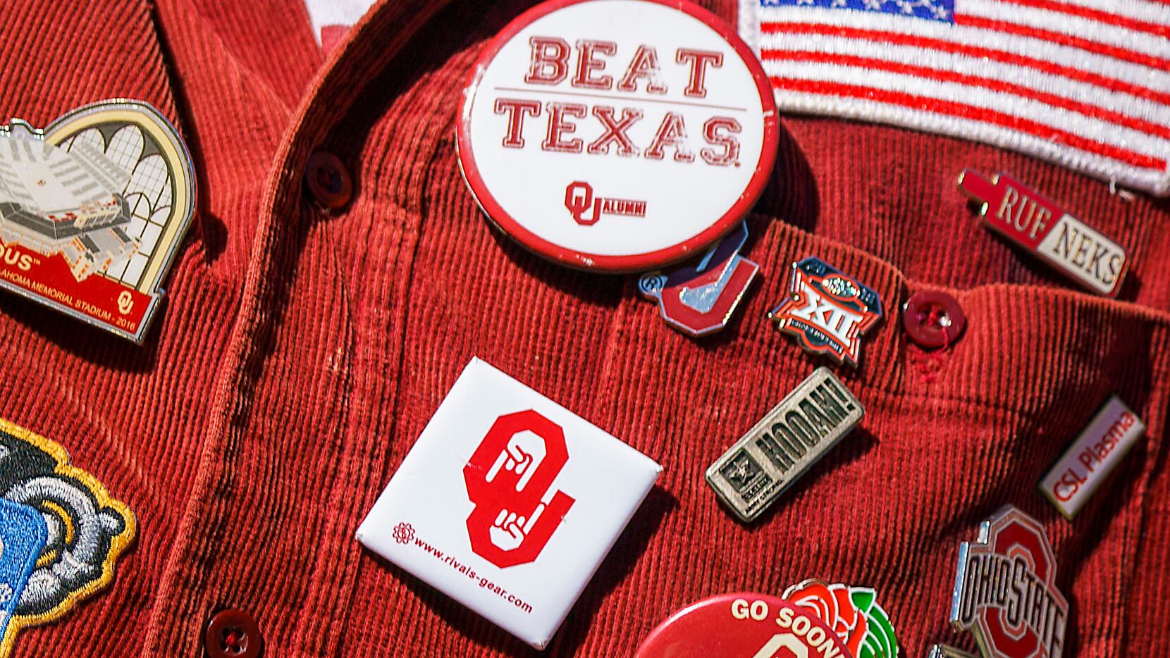 A Oklahoma Ruf Nek wears a weathered "Beat Texas" button during the second half of an NCAA...