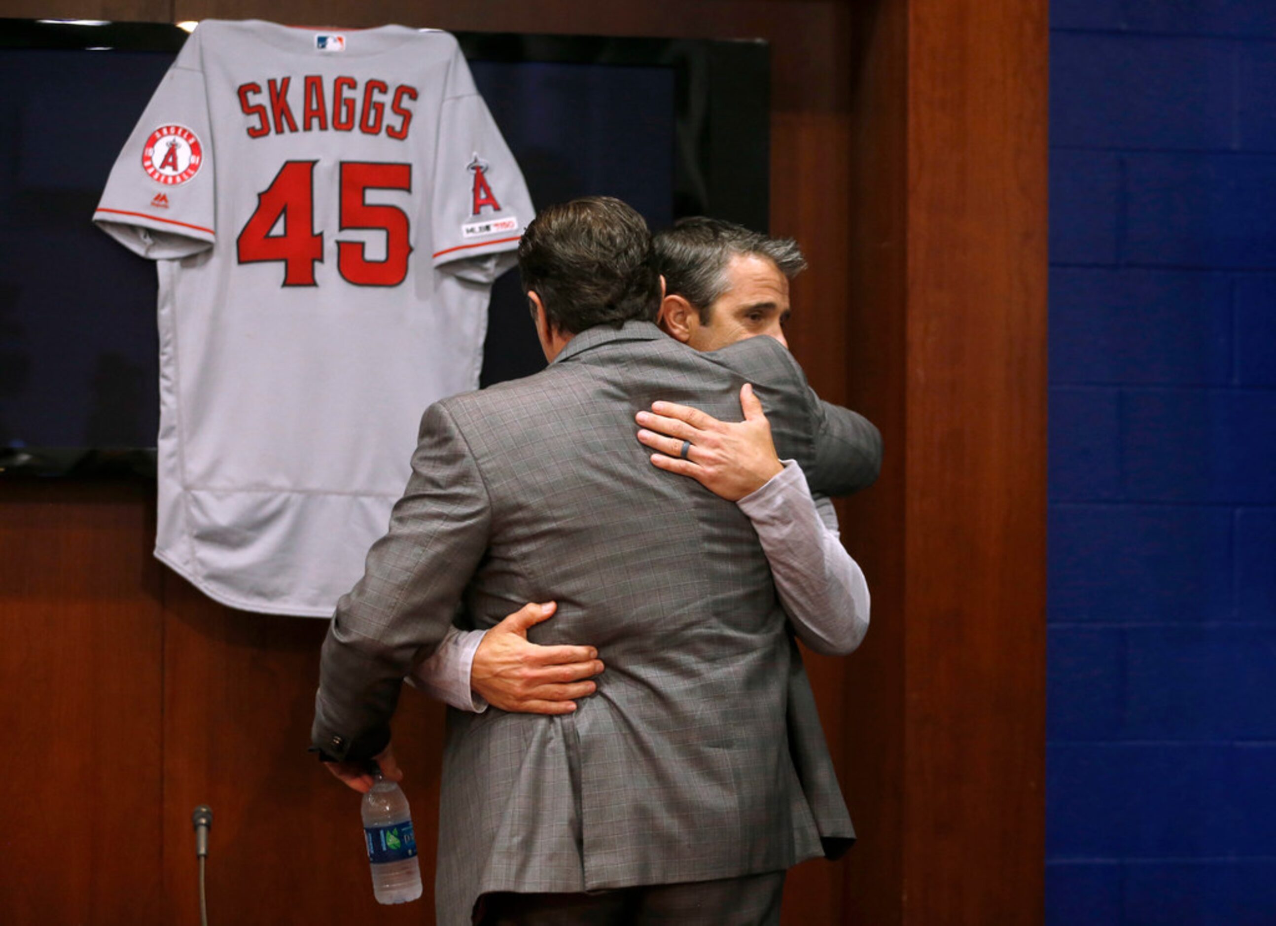 Los Angeles Angels manager Brad Ausmus and president John Carpino hug after a press...