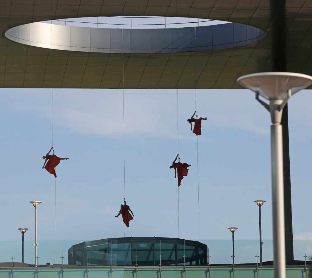 Aerial dancers perform on the Toyota building at the grand opening ceremony of the Toyota...