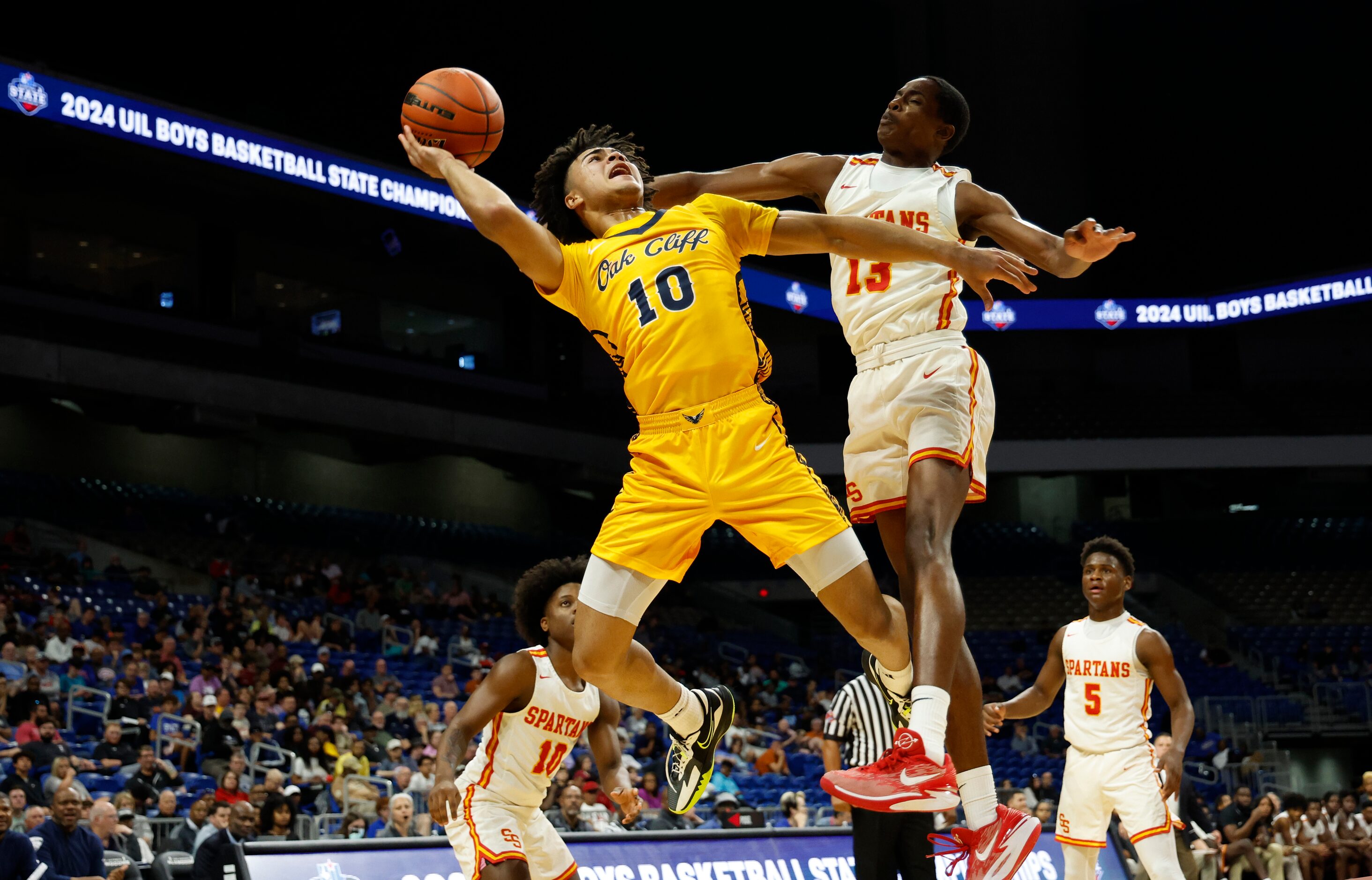 Faith Family's Isaac Williams (10) is fouled by Stafford's Christian Chambers (13) In the...