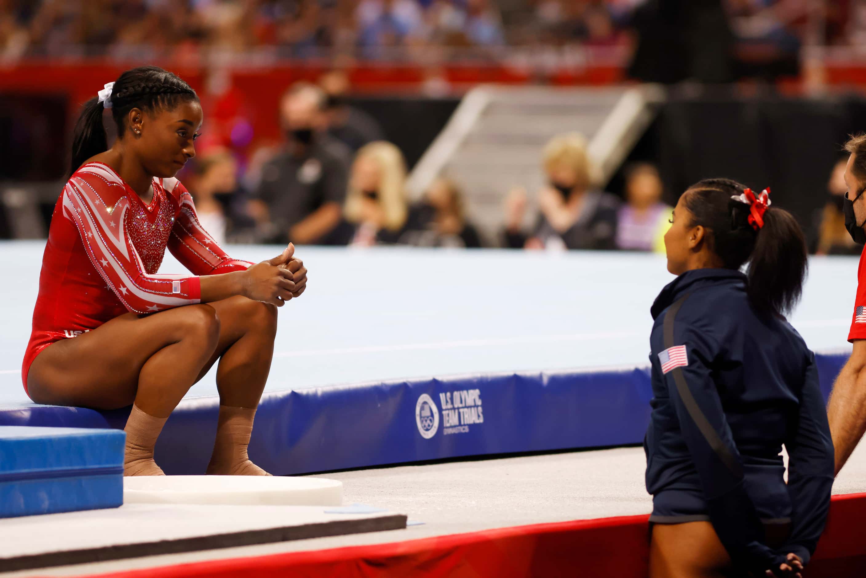 Simone Biles talks with Jordan Chiles before competing on the floor during day 2 of the...
