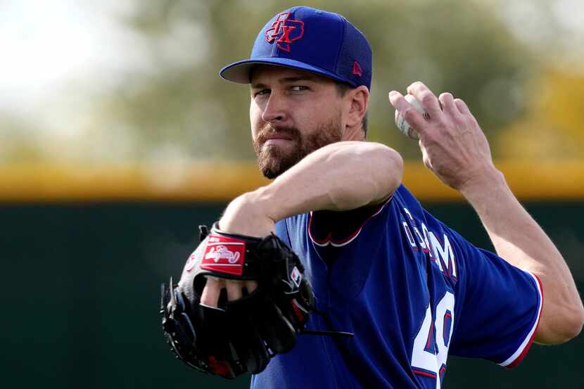 Texas Rangers pitcher Jacob deGrom throws during spring training baseball practice Sunday,...