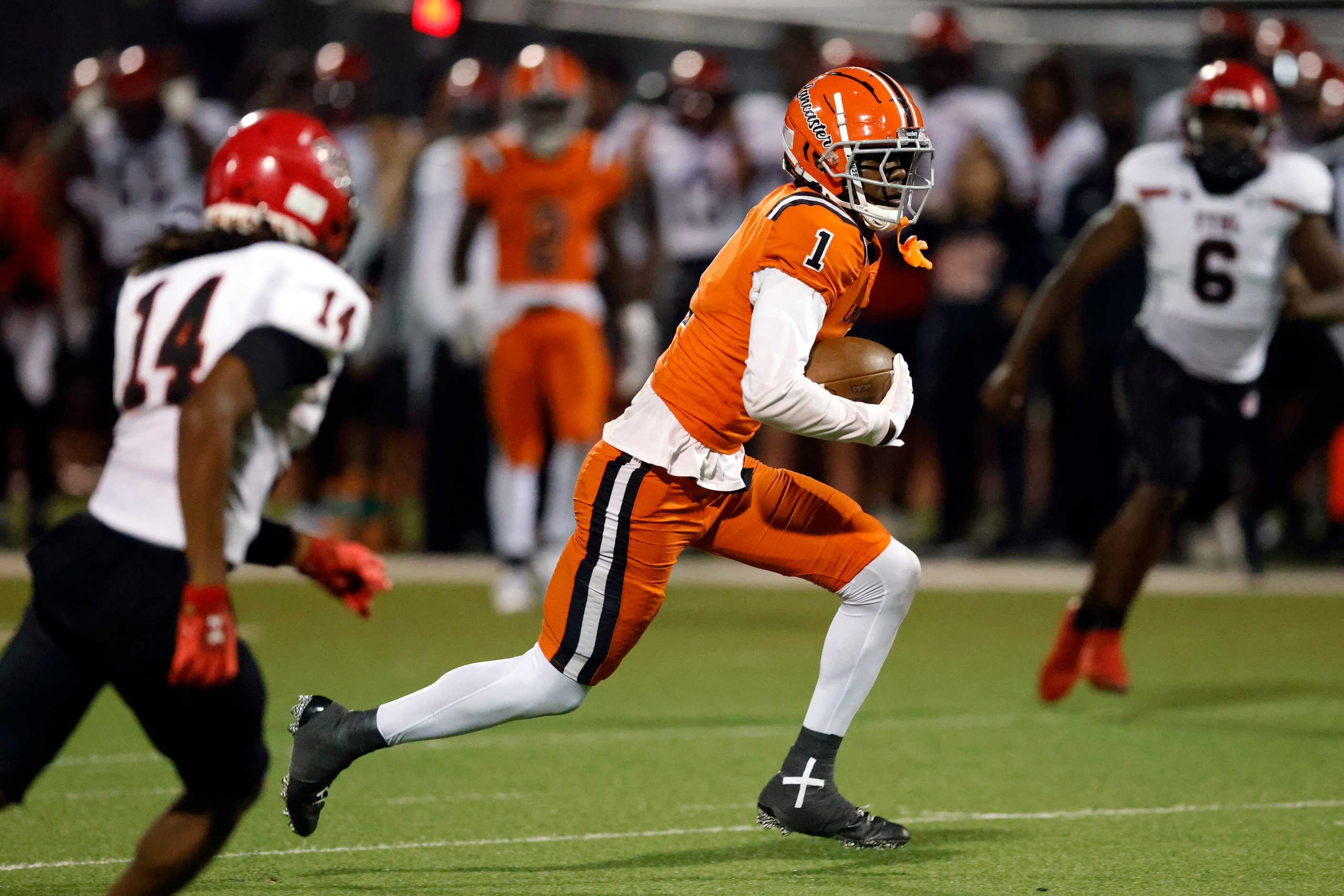 Lancaster wide receiver Emmanuel Choice (1) runs after a catch for a 56 yard touchdown ahead...