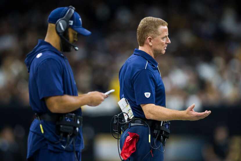 Dallas Cowboys head coach Jason Garrett signals to an official with passing game coordinator...