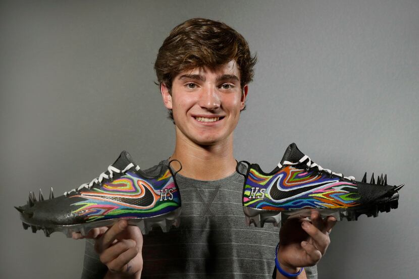 Luke Savage, 16, holds a finished pair of cleats he created for SportsDayHS in his home in...