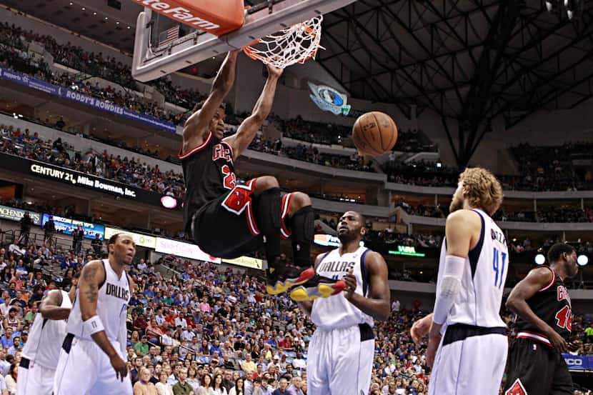 Dallas Mavericks look on as Chicago Bulls small forward Jimmy Butler makes an uncontested...