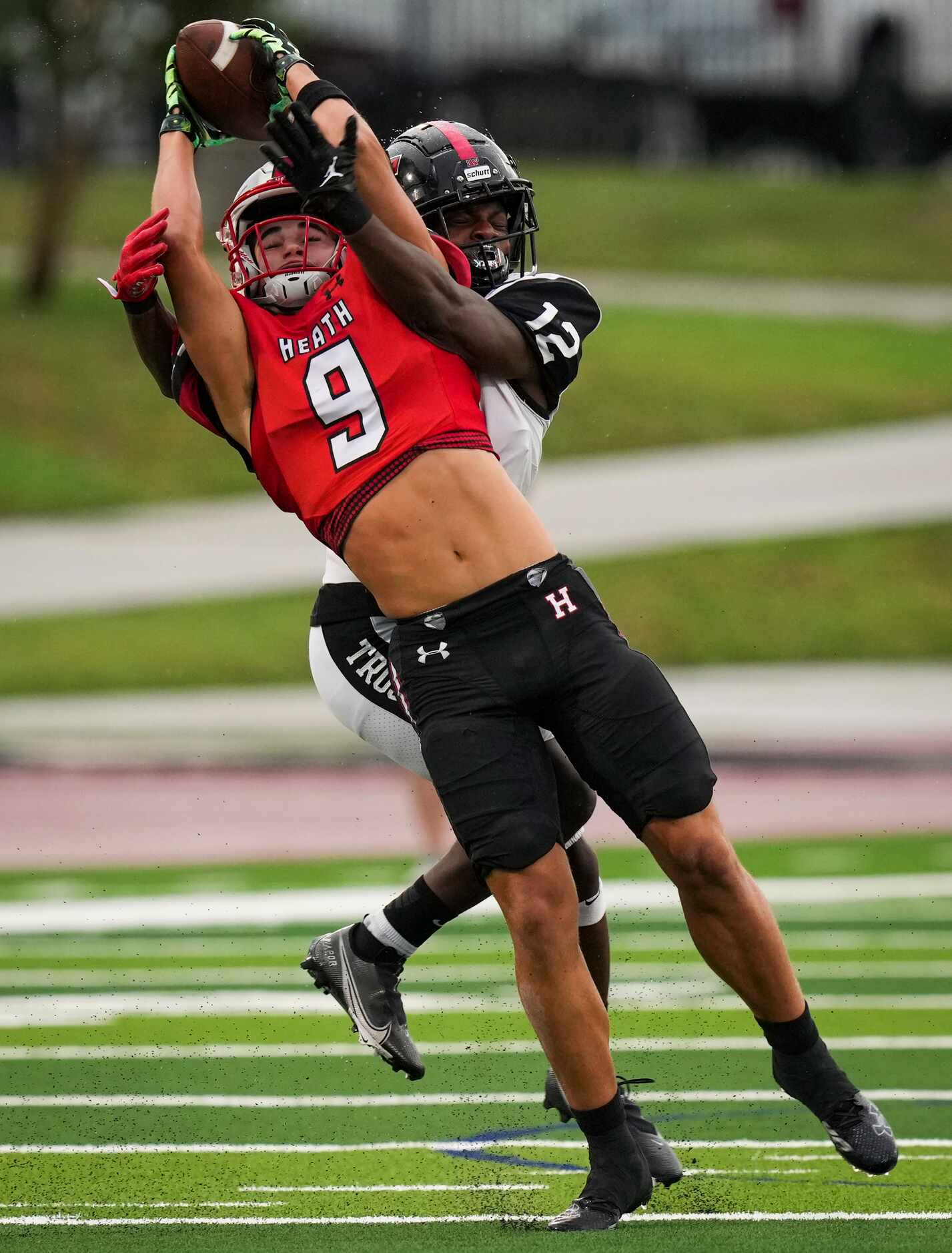 Euless Trinity defensive back Lamont Potts (12) breaks up a pass intended for Rockwall-Heath...