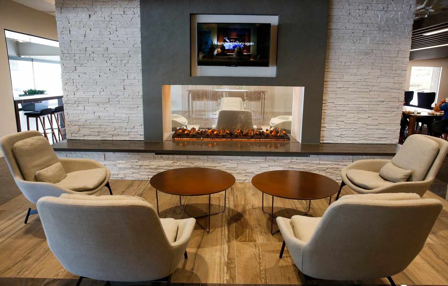 A lounge area in front of a fireplace in the tenant lounge in The Towers at Williams Square.