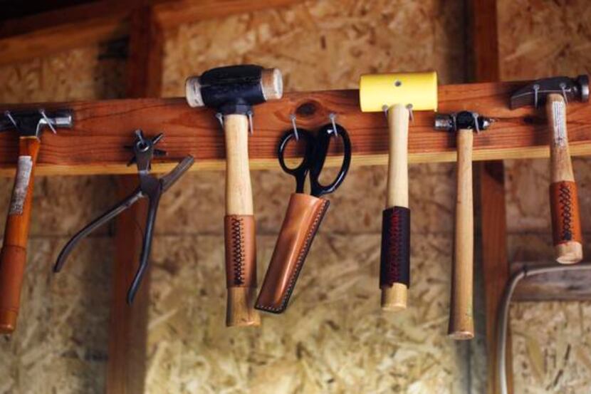 
Some of the tools of Seth Cummings, who works on a variety of leather items as part of a...