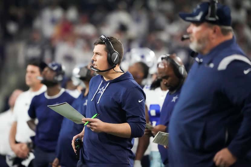 Dallas Cowboys offensive coordinator Kellen Moore works on the sidelines during the second...