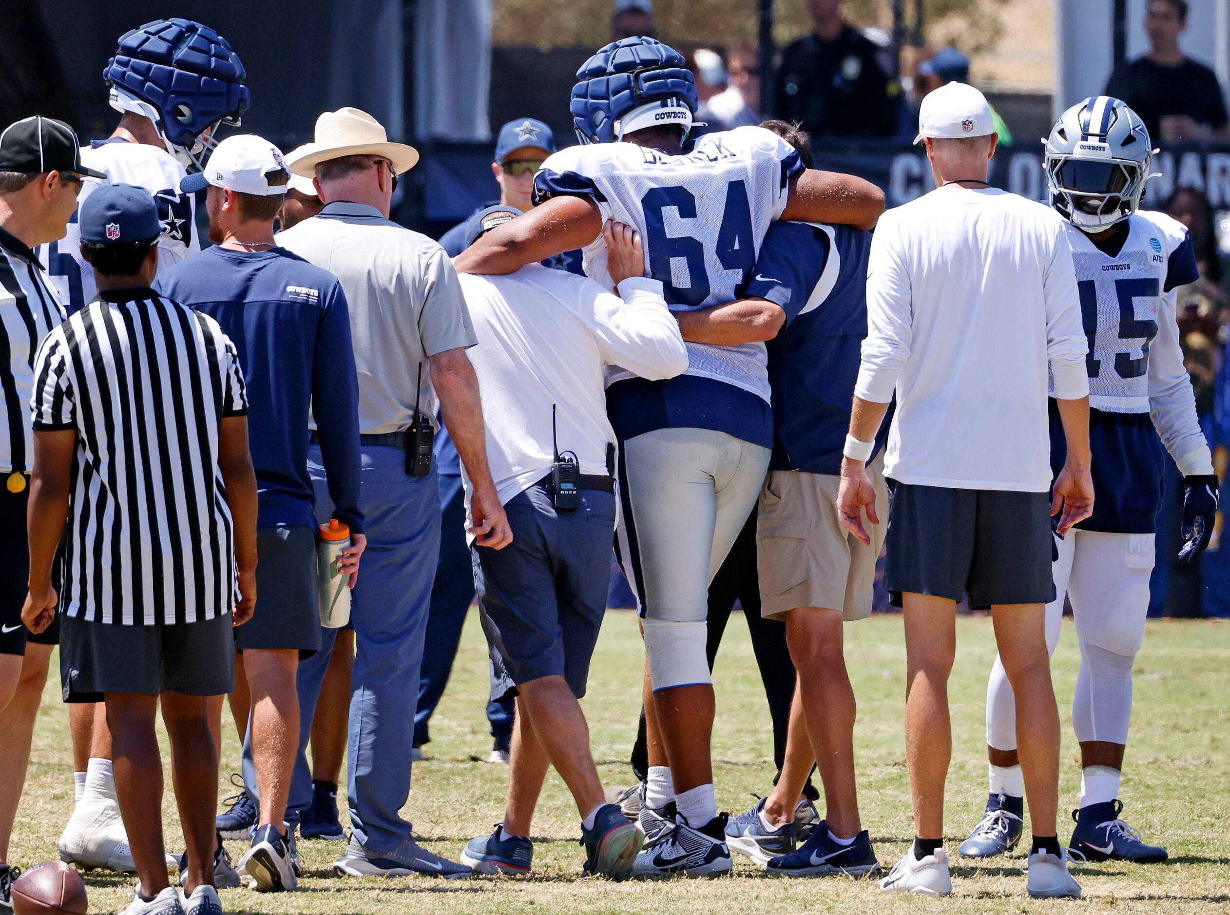 Dallas Cowboys offensive tackle Earl Bostick Jr. (64) who went down with an injury is helped...