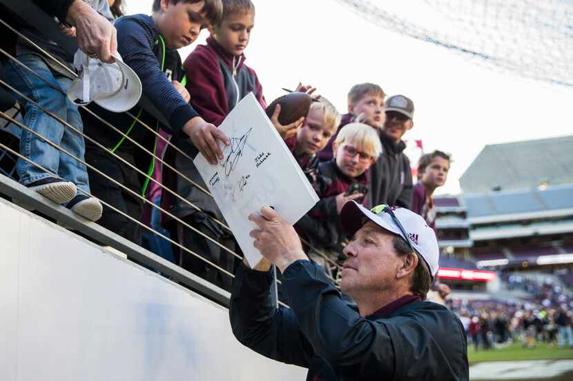 Texas A&M Aggies head coach Jimbo Fisher signs autographs after a Texas A&M University...