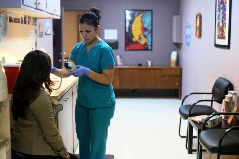 
A medical assistant helps a patient through a pre-op appointment during the final day of...