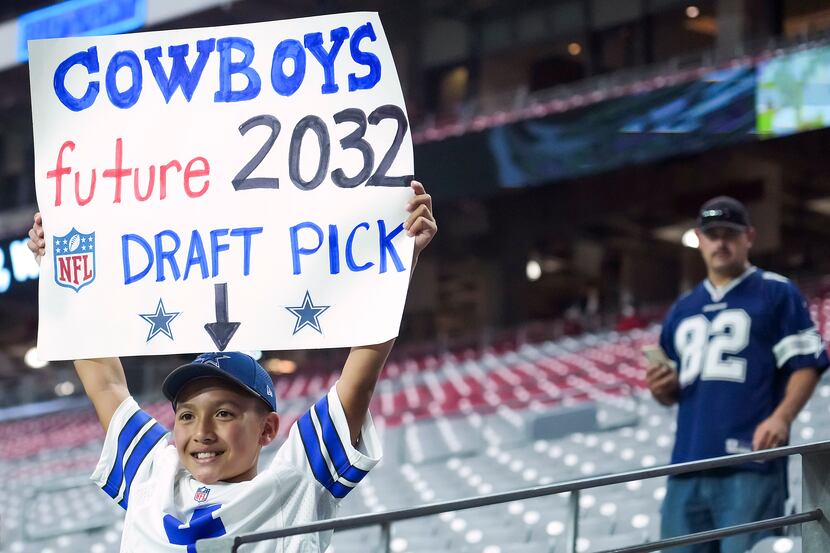 Eleven-year-old Cowboys fan Marcus Serrano held up a sign before a preseason game Aug. 13,...