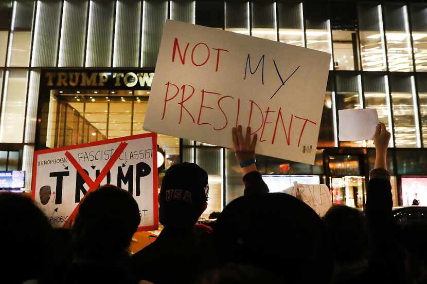 Anti-Trump protesters gathered Thursday outside Trump Tower in New York. (Spencer...