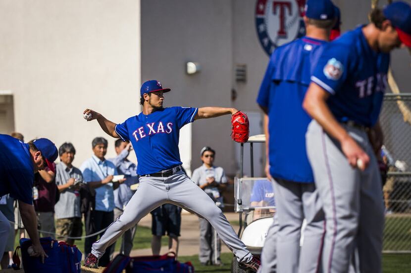 Texas Rangers pitcher Yu Darvish throws off a pitching mound in the bullpen during a spring...